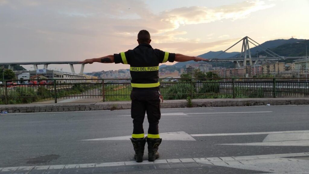 Un pompiere di fronte al Ponte Morandi di Genova, dopo il crollo